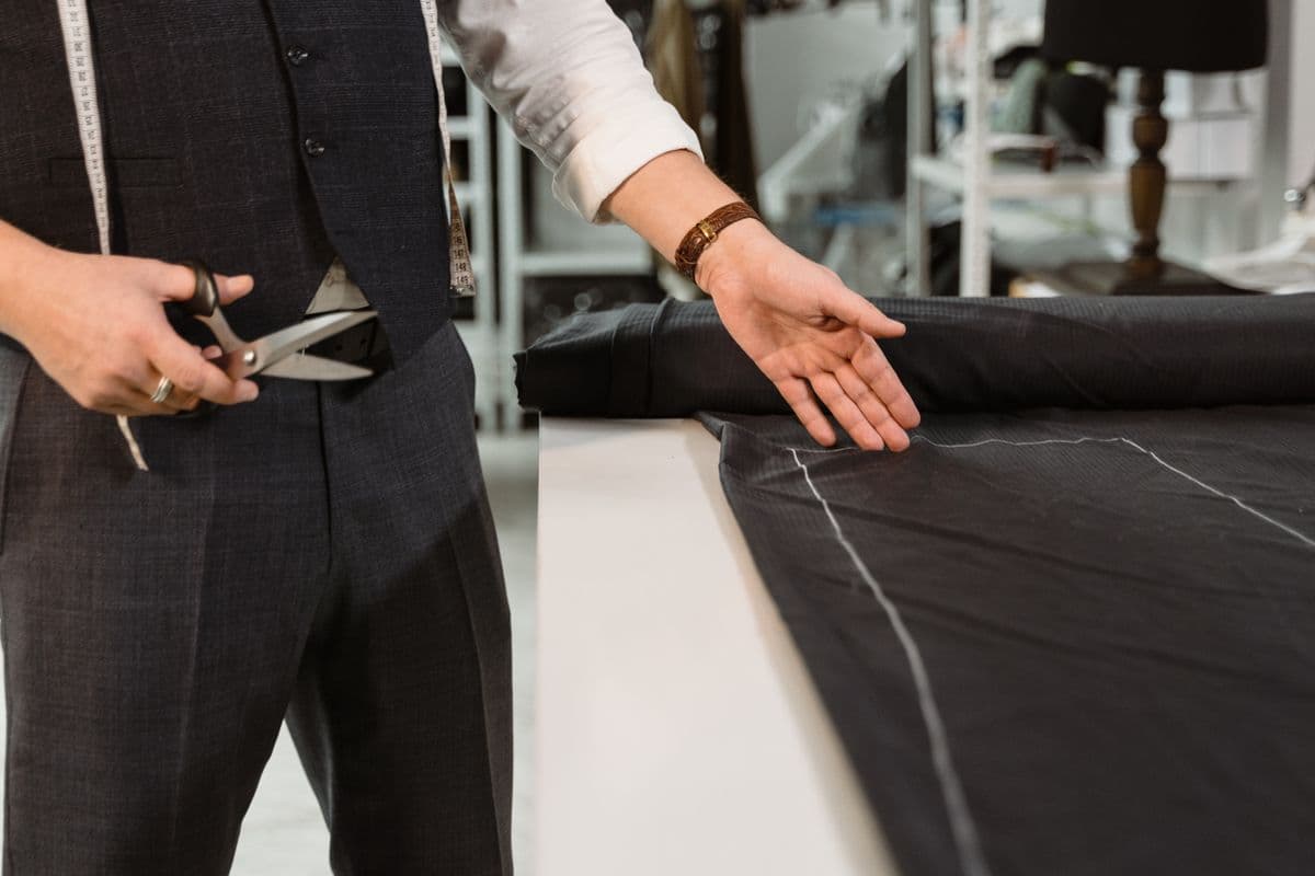 Close-up of a tailor precisely cutting premium fabric