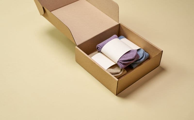 Neatly folded clothing essentials in a gift box
