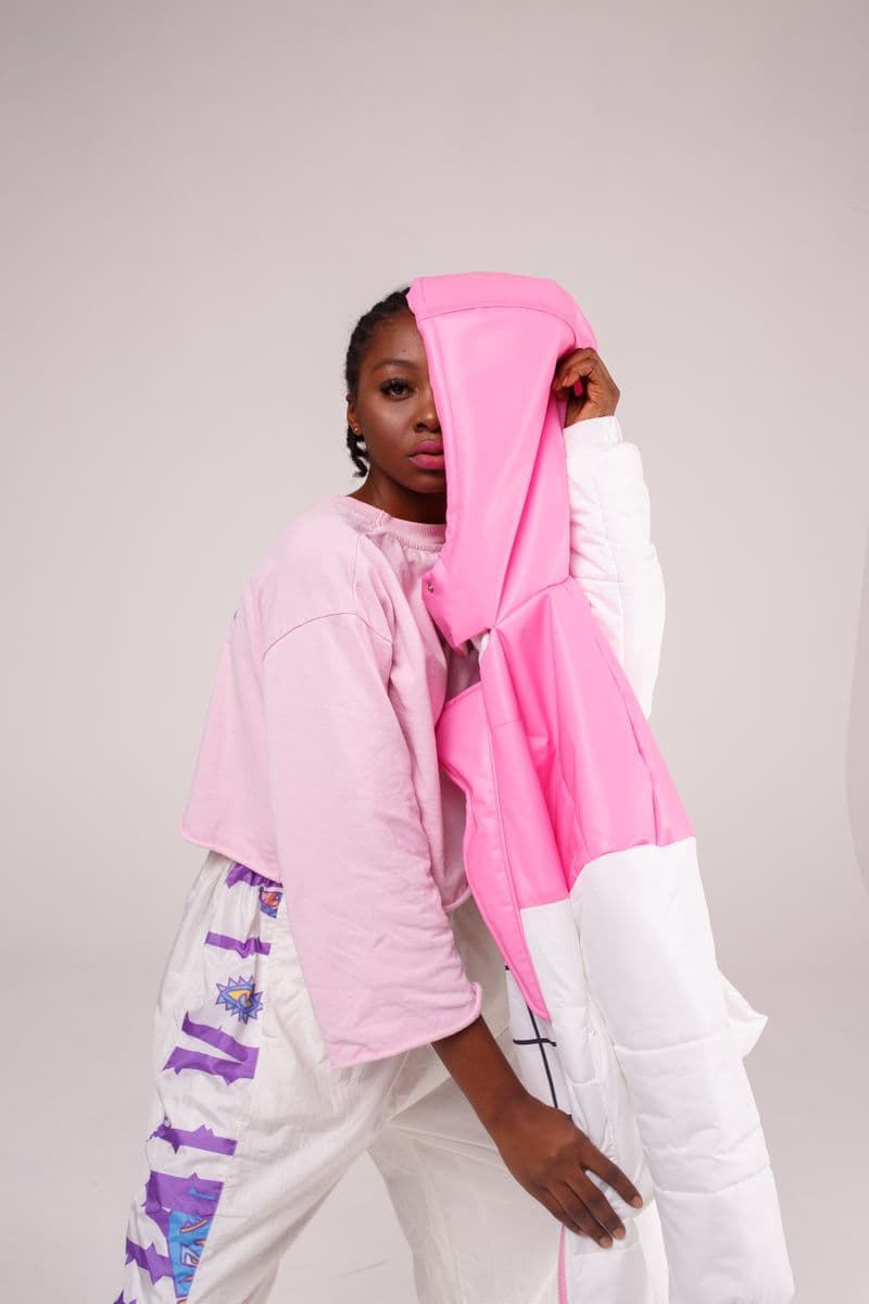 Person in a soft pink hooded outfit
